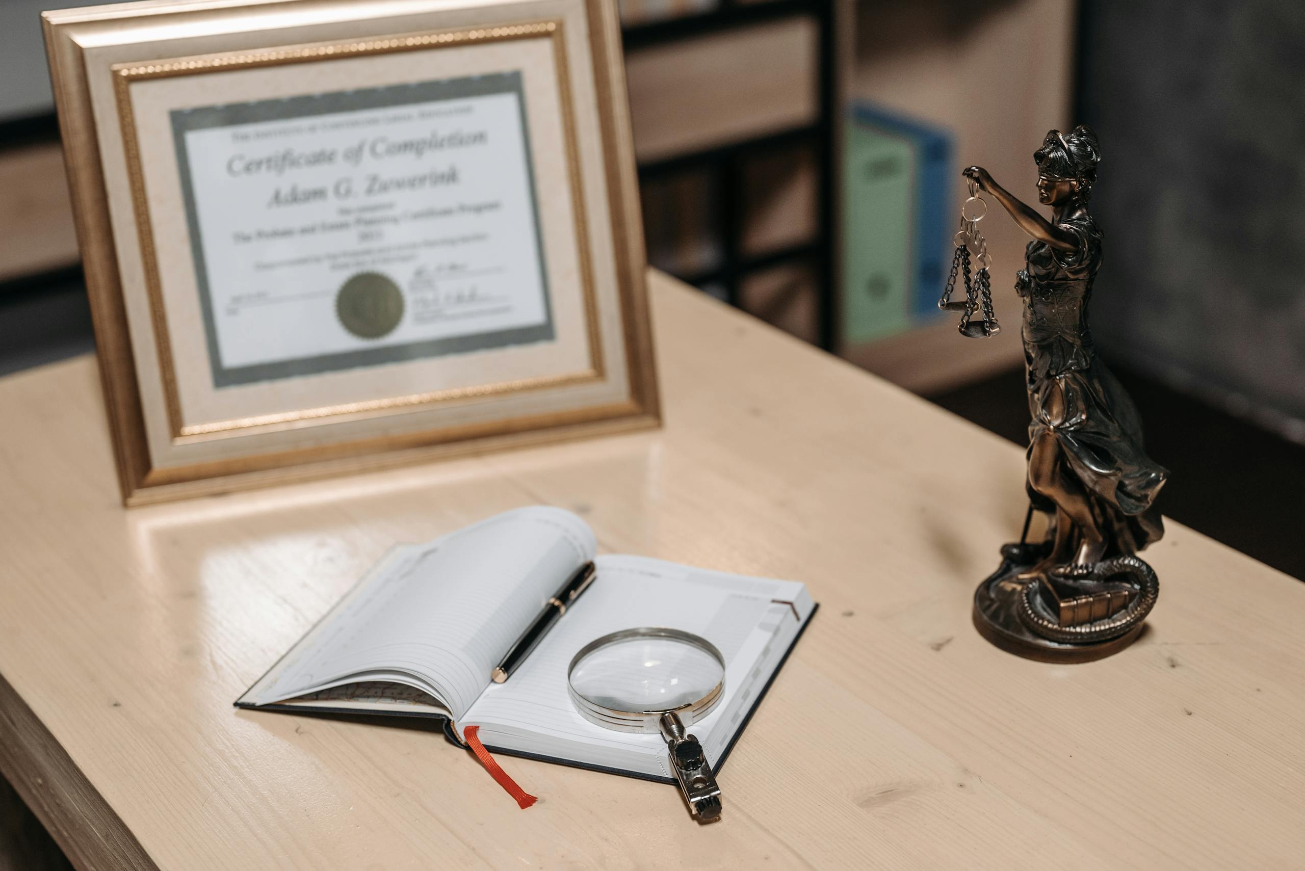 An Open Book on the Table with Magnifying Glass and a Pen